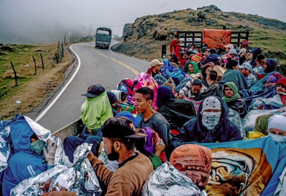 Venezuelan migrants in a flatbed truck crossing the Colombian mountains