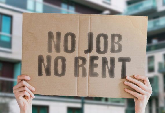 The phrase " No job no rent " on a banner in hand with blurred background.